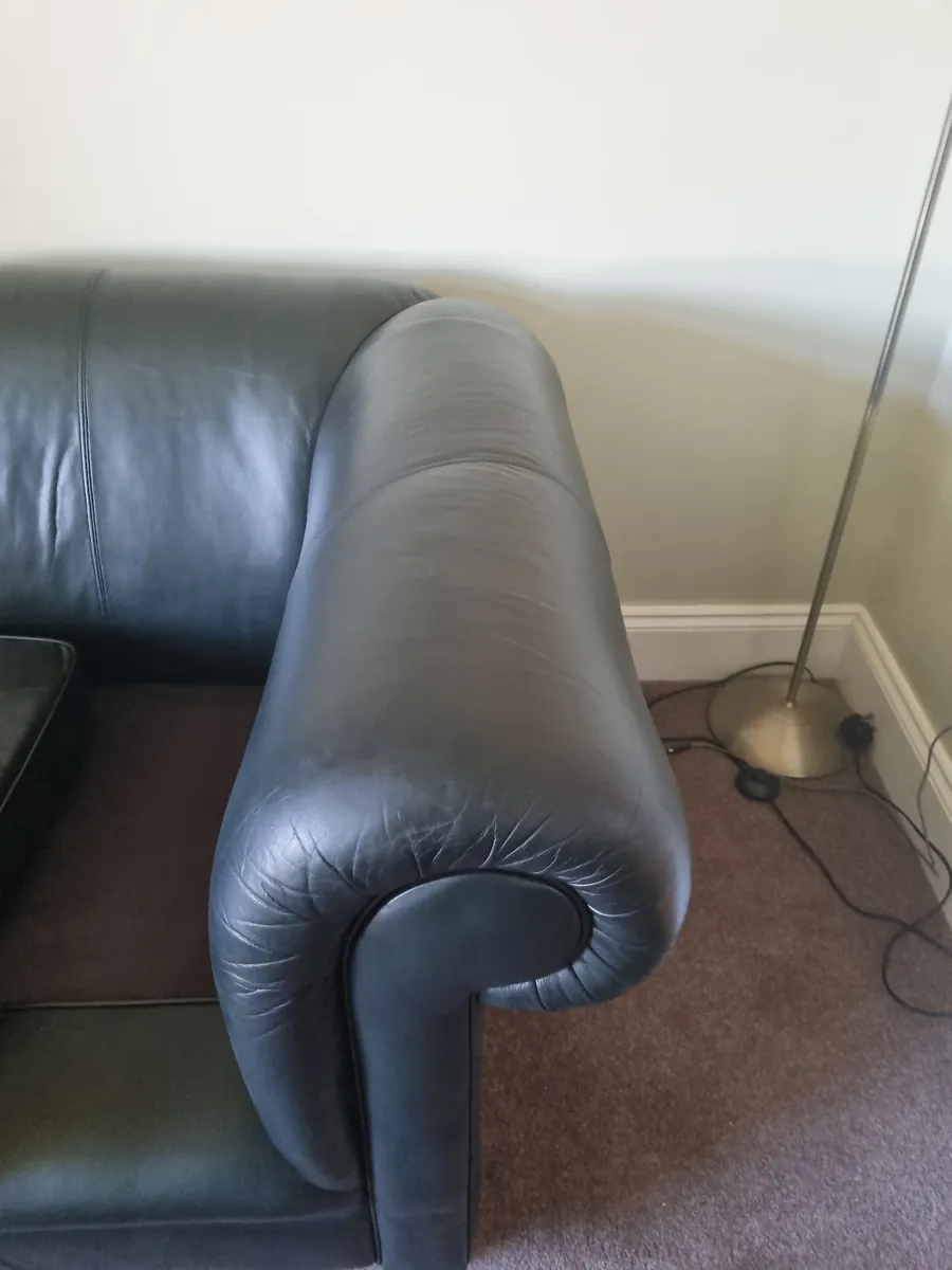 Dark leather sofa arm after recolouring, with a smooth even finish