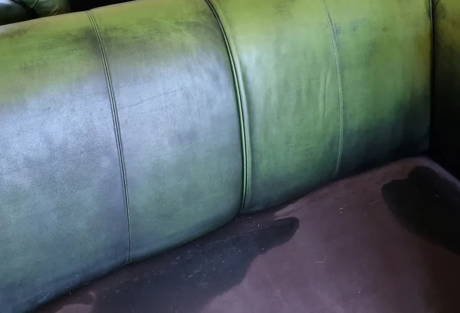Mottled, faded green leather sofa before recolouring