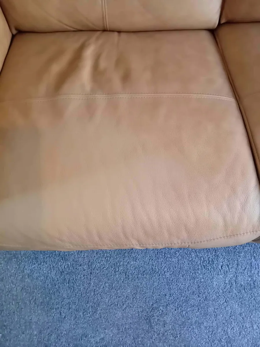 The same style of tan leather seat repaired, with a smooth even finish